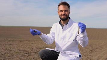 Scientist studying sample of soil in field video