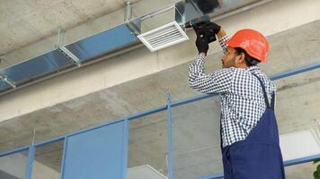 Indian hvac worker install ducted pipe system for ventilation and air conditioning video
