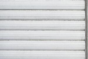 Closed plastic blinds for windows, close-up. external side. White color. traces of time photo
