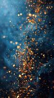Golden particles in flight against a golden bokeh background. Vertical blurred background. photo