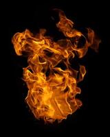 Fire and burning flame of explosive fireball isolated on dark background for abstract graphic design photo