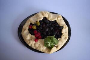 the process of making galette pie with mulberry photo