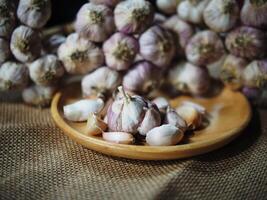 fresh garlic bundle and cooking in kitchen texture photo