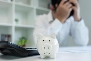 Stressed and headache man with large bills or invoices no money to pay to expenses and credit card debt. shortage, Financial problem, bankruptcy, mortgage, loan, bankrupt, poor, empty wallet photo