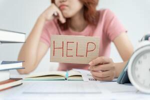 Asian student woman have anxiety because of exams, female prepare for test and learning lessons in the library. stress, despair, haste, misunderstanding reading, discouraged, expectation, knowledge photo