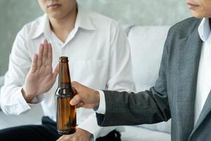 refuses say no and avoid to drink an alcohol , hand show reject and stopping, alcoholism treatment, alcohol addiction, quit booze, Stop Drinking Alcohol. Refuse bottle liquor, unhealthy photo