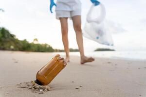 Save water. Volunteer pick up trash garbage at the beach and plastic bottles are difficult decompose prevent harm aquatic life. Earth, Environment, Greening planet, reduce global warming, Save world photo