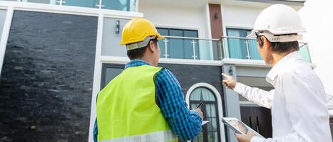 inspector engineer and owner project is inspecting construction and quality assurance new house. Engineers or architects or contactor work to build the house before handing it over to the homeowner photo