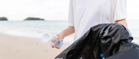 Save water. Volunteer pick up trash garbage at the beach and plastic bottles are difficult decompose prevent harm aquatic life. Earth, Environment, Greening planet, reduce global warming, Save world photo