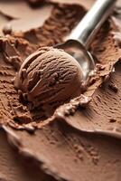 Vertical image with chocolate ice cream surface and scoop spoon making one ice cream ball. Cafe business. Background with place for text. photo