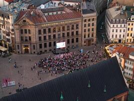 Aerial View of Crowd in Riga City Square with Large Screen Display photo