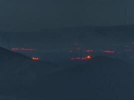 Aerial View of Volcanic Eruption with Red Lava Flows in Iceland photo