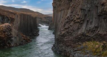 Aerial View of Whitewater River Flowing Through Basalt Canyon in Iceland photo
