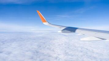 air plan wing, blue sky and clouds, view from windows. High quality photo