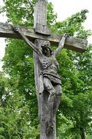 a wooden cross with a man on it photo