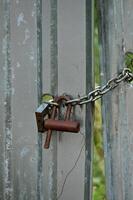a chain and padlock attached to a fence photo