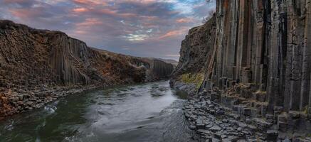 Aerial View of River Flowing Through Basalt Canyon in Iceland at Dusk photo