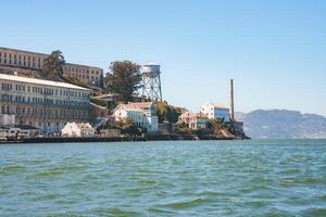 Discover the iconic Alcatraz Island in San Francisco Bay, California, USA, showcasing historical prison buildings, water tower, and scenic coastline views. photo