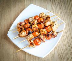 Grilled chicken skewers with cherry tomatoes photo
