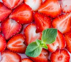 Mint leaves and sliced Strawberries at background photo