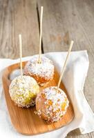 Caramelized apple on the wooden stick photo