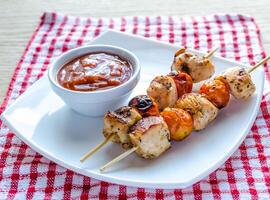 Grilled chicken skewers with cherry tomatoes photo