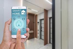 Young woman holding smart phone with launched security application at home. Concept of controlling and managing home security from a mobile device photo