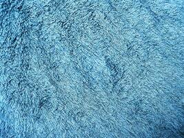Blue background of towel texture. Beautifully folded white towels. Macro photo of beach towel. Soft textile background