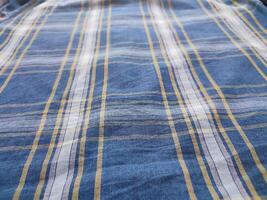The texture of the shirt fabric has a checkered pattern photo