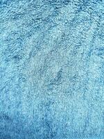 Blue background of towel texture. Beautifully folded white towels. Macro photo of beach towel. Soft textile background