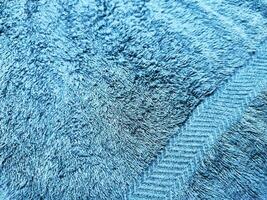Blue background of towel texture. Beautifully folded white towels. Macro photo of beach towel. Soft textile background