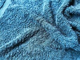 Blue background of towel texture. Beautifully folded white towels. Macro photo of beach towel. Soft textile background
