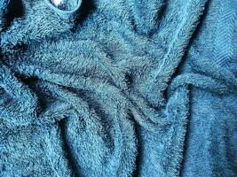 Blue background of towel texture. Beautifully folded white towels. Macro photo of beach towel. Soft textile background