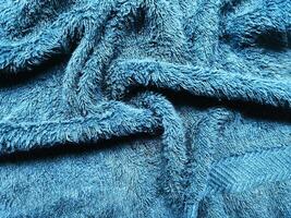 Blue background of towel texture. Beautifully folded white towels. Macro photo of beach towel. Soft textile background