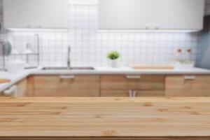 Wood table top on blurred kitchen background. can be used mock up for montage products display or design layout photo