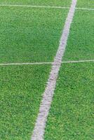 detail of the center line in a synthetic grass surface of a football field photo