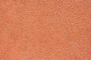 Orange tartan surface of a running track as texture, background photo