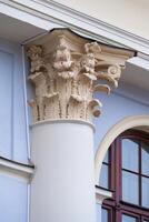 Close up view on Corinthian capital on a semi-column of ancient building photo