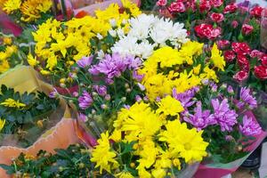 View of different assortment of flowers bouquets with multi-colored chrysanthemums and roses in store photo