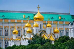 Close up view on a Annunciation Cathedral of the Moscow Kremlin with golden domes on a background of The Grand Kremlin Palace photo