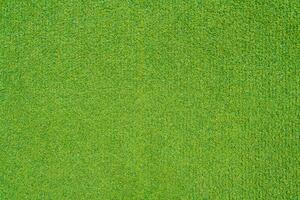 Artificial green grass on the playground as texture, background photo