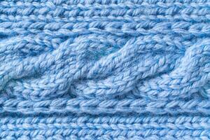 Blue woolen fabric with a fragment of a pigtail pattern photo