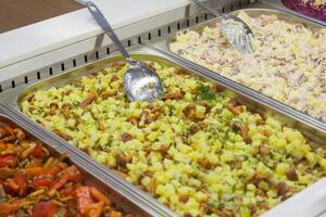 View of a different prepared salads on the counter in the store photo