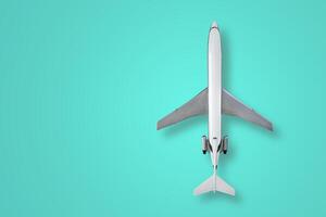 Top view of a aircraft model with shadow on a turquoise background photo