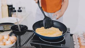 detail shot of a woman removing an egg from the frying pan with a spatula, preparing the typical colombian breakfast video