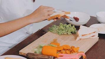 Detail of female hands adding salami on a sandwich woman making hot sandwiches for breakfast in a sandwich maker video