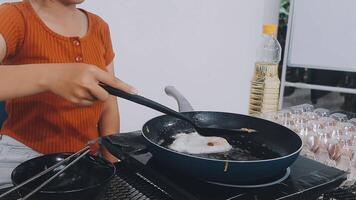 detail shot of a woman removing an egg from the frying pan with a spatula, preparing the typical colombian breakfast video