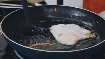 detail shot of a woman removing an egg from the frying pan with a spatula, preparing the typical colombian breakfast video