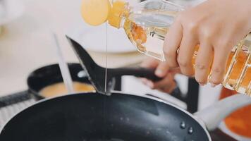 detail shot of a woman removing an egg from the frying pan with a spatula, preparing the typical colombian breakfast video