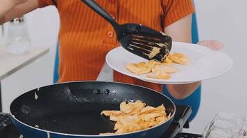 detail shot of a woman removing an egg from the frying pan with a spatula, preparing the typical colombian breakfast video